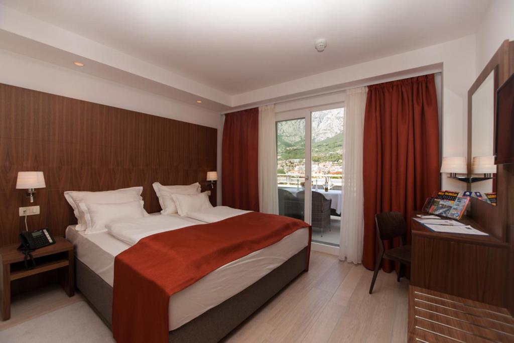 Posteľ alebo postele v izbe v ubytovaní Aparthotel Miramare