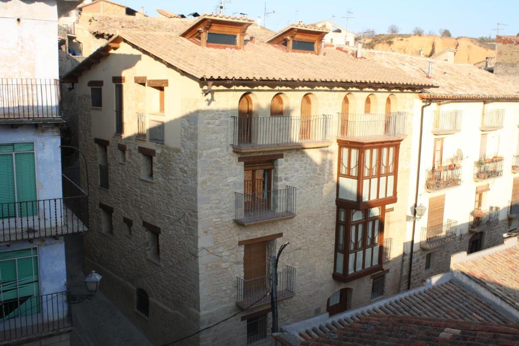 a group of buildings with balconies and roofs at Apartamentos Doña Candida in Valderrobres