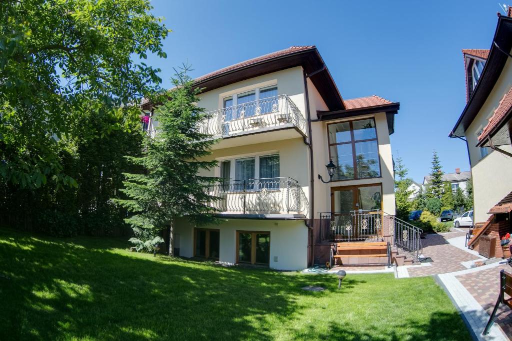 a large white house with a yard at Willa Jasiu in Władysławowo