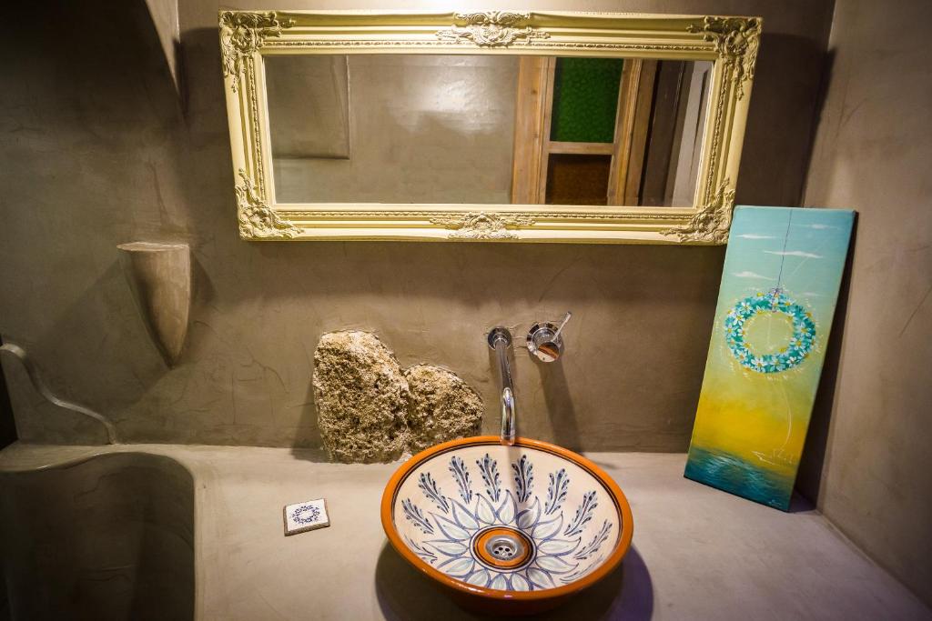 a bathroom counter with a sink and a mirror at Rodi in Rhodes Town