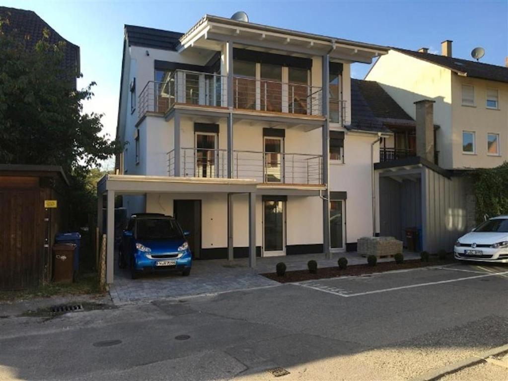 a car parked in a parking lot in front of a house at Ferienhaus Carpe diem in Bodman-Ludwigshafen