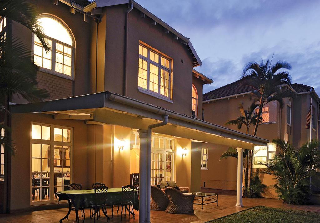 a house with a table in front of it at Sica's Guest House Musgrave in Durban