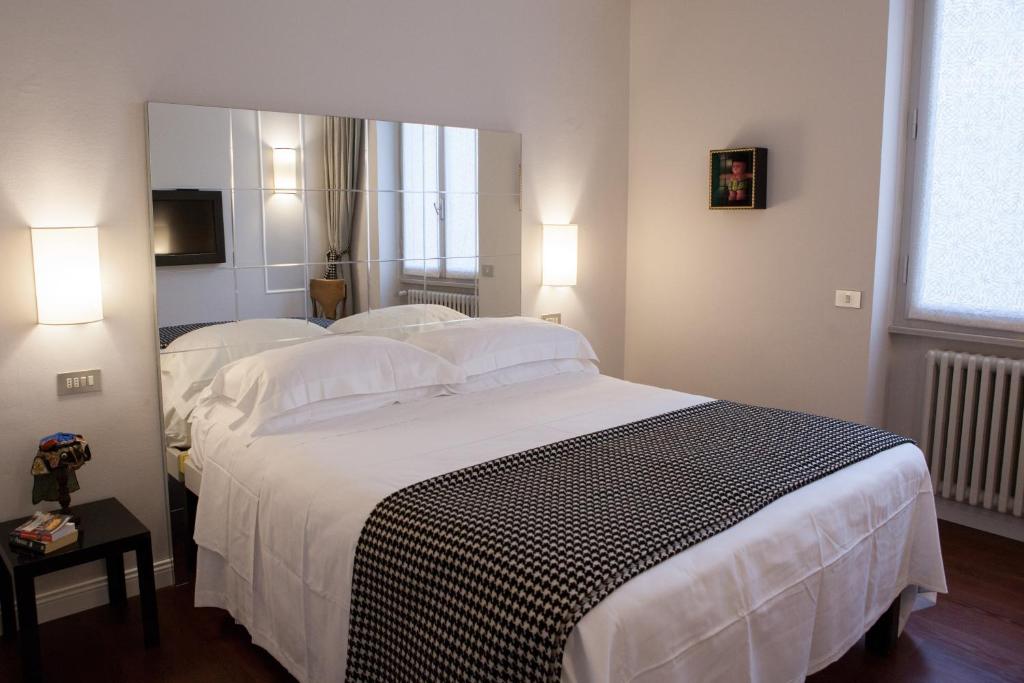 Säng eller sängar i ett rum på Verdi Apartments