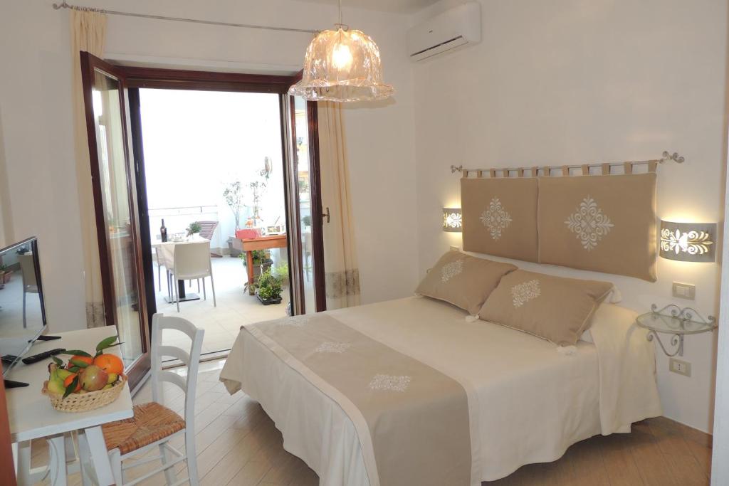 a bedroom with a bed and a table with a mirror at La Terrazza in Oristano