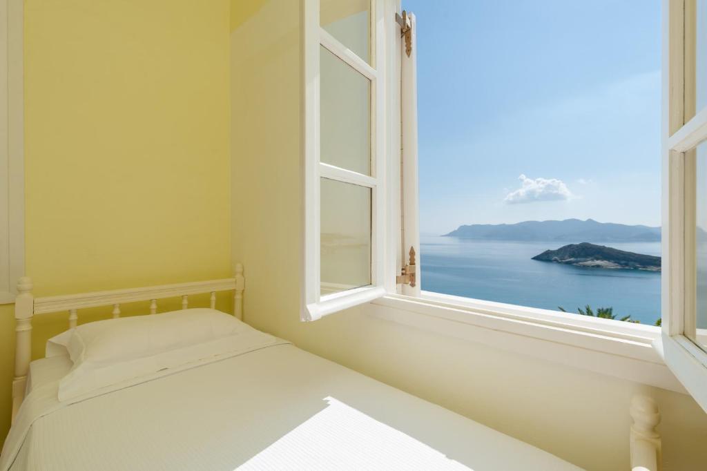 a bedroom with a window with a view of the ocean at Kimolia Gi in Kimolos