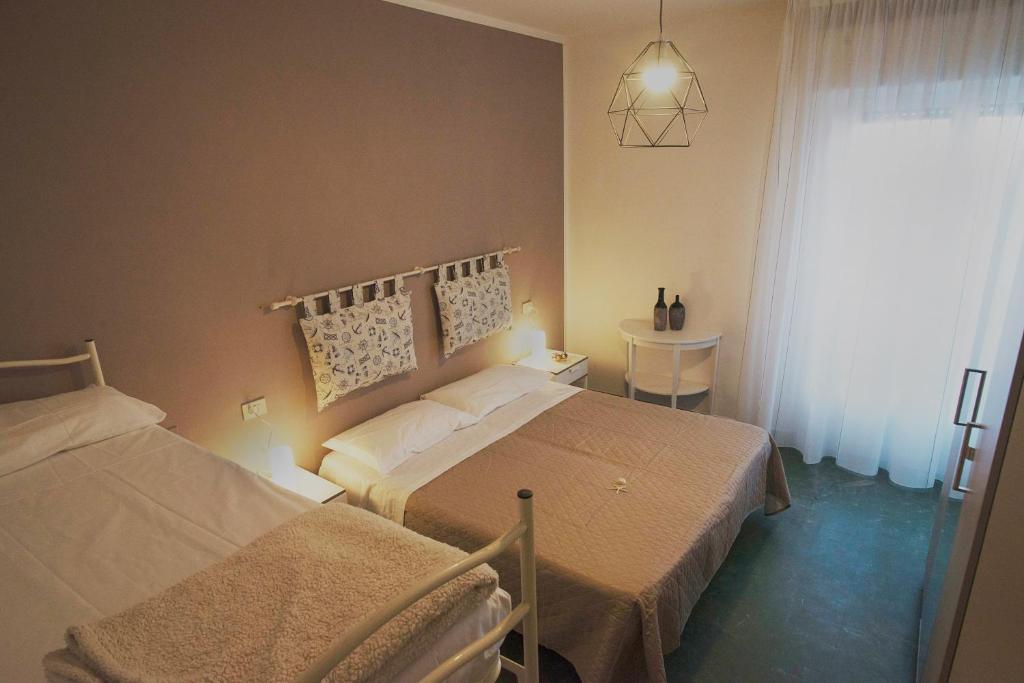 Postel nebo postele na pokoji v ubytování Hotel 21 Riccione