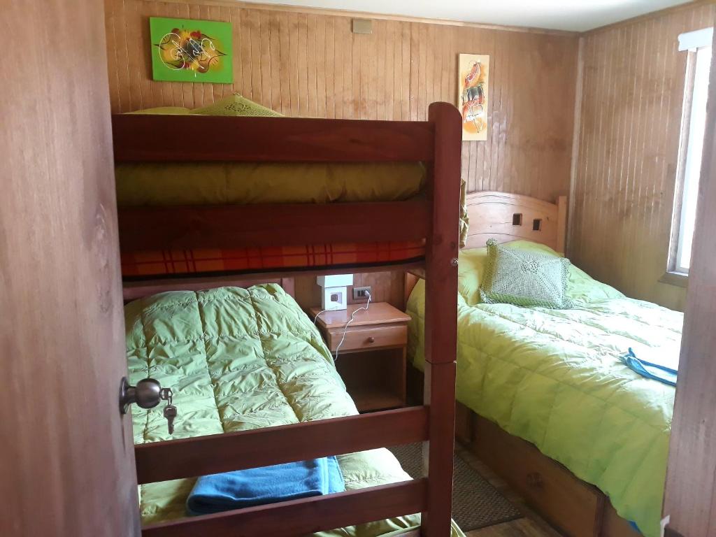Voodi või voodid majutusasutuse Cabañas & Hostal Lefuco toas