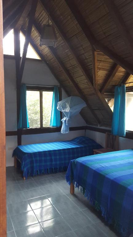 Postel nebo postele na pokoji v ubytování Las Cabañas de la Iguana