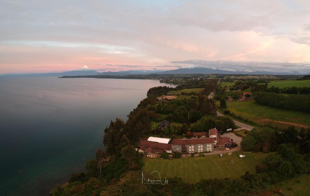 an aerial view of a house next to the water at Hotel Borde Lago in Puerto Varas