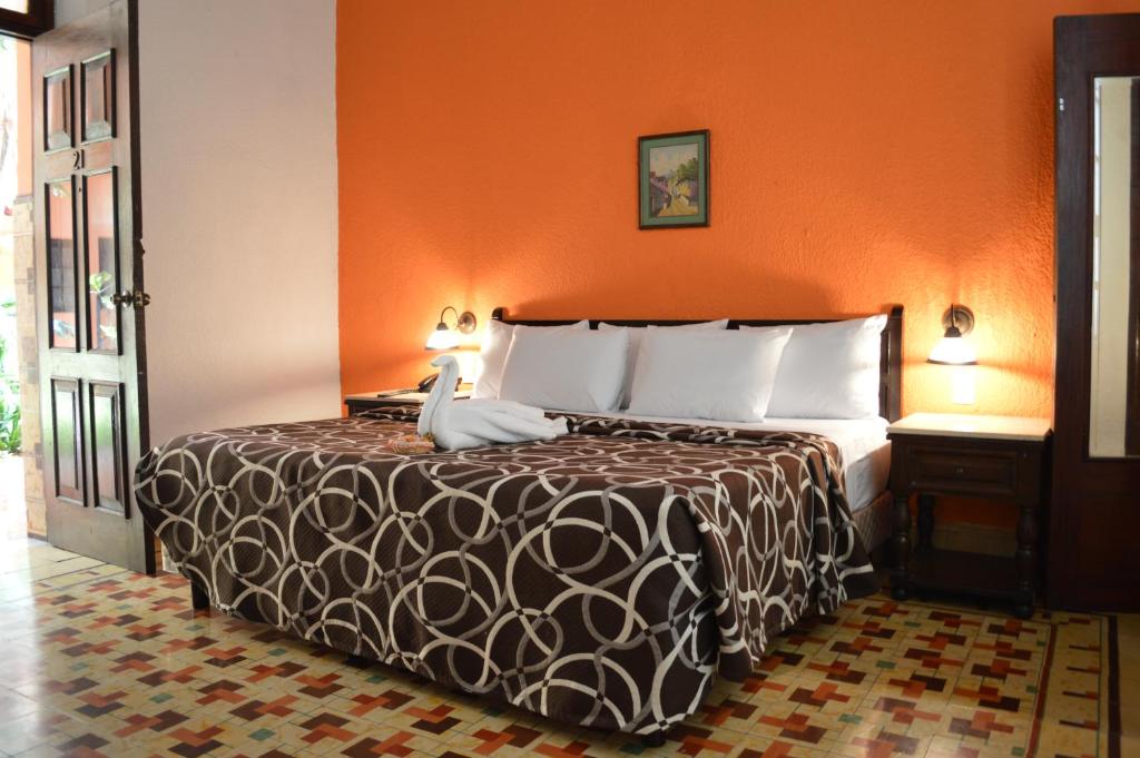 Postel nebo postele na pokoji v ubytování Hotel Colon Merida