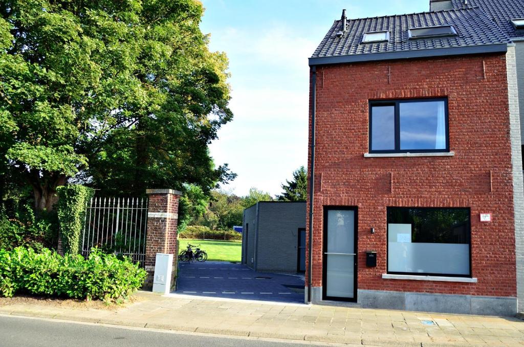 a red brick house with a door on the side of it at Nena Guesthouse in Leuven