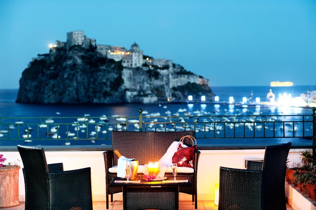a table with chairs and a table cloth on top of it at Hotel Ulisse in Ischia