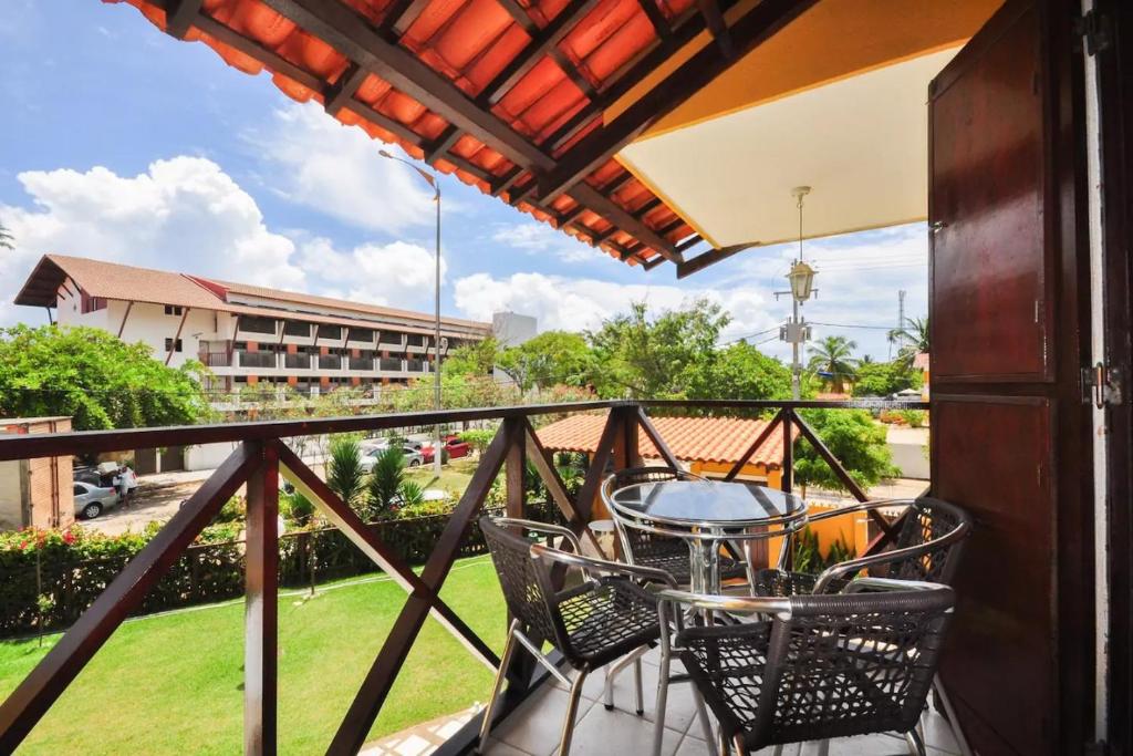 een balkon met een tafel en stoelen en een gebouw bij Merepe Residencial in Porto De Galinhas
