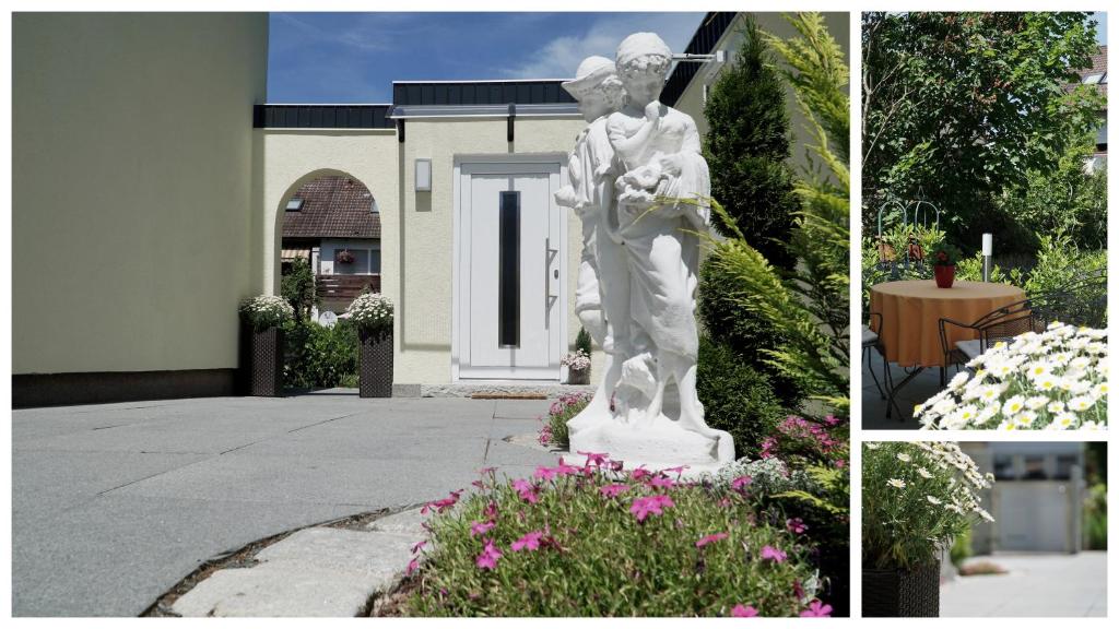 une statue d'un homme et d'une femme dans un jardin dans l'établissement Bungalow am Stadtrand, à Nuremberg