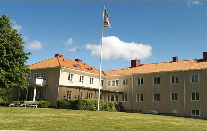 a large building with a flag on top of it at Partille Vandrarhem in Partille