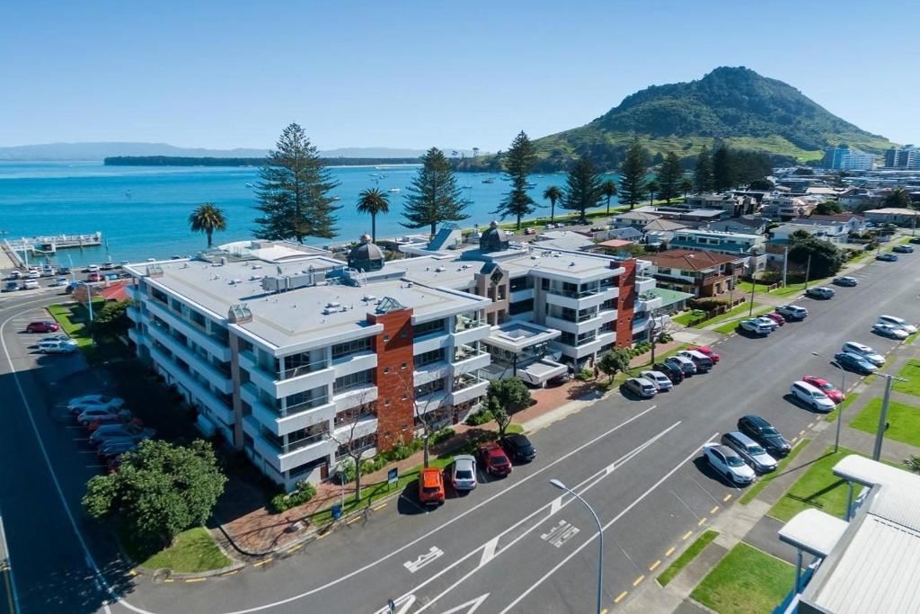 an aerial view of a city with a parking lot at The Anchorage Apartments in Mount Maunganui
