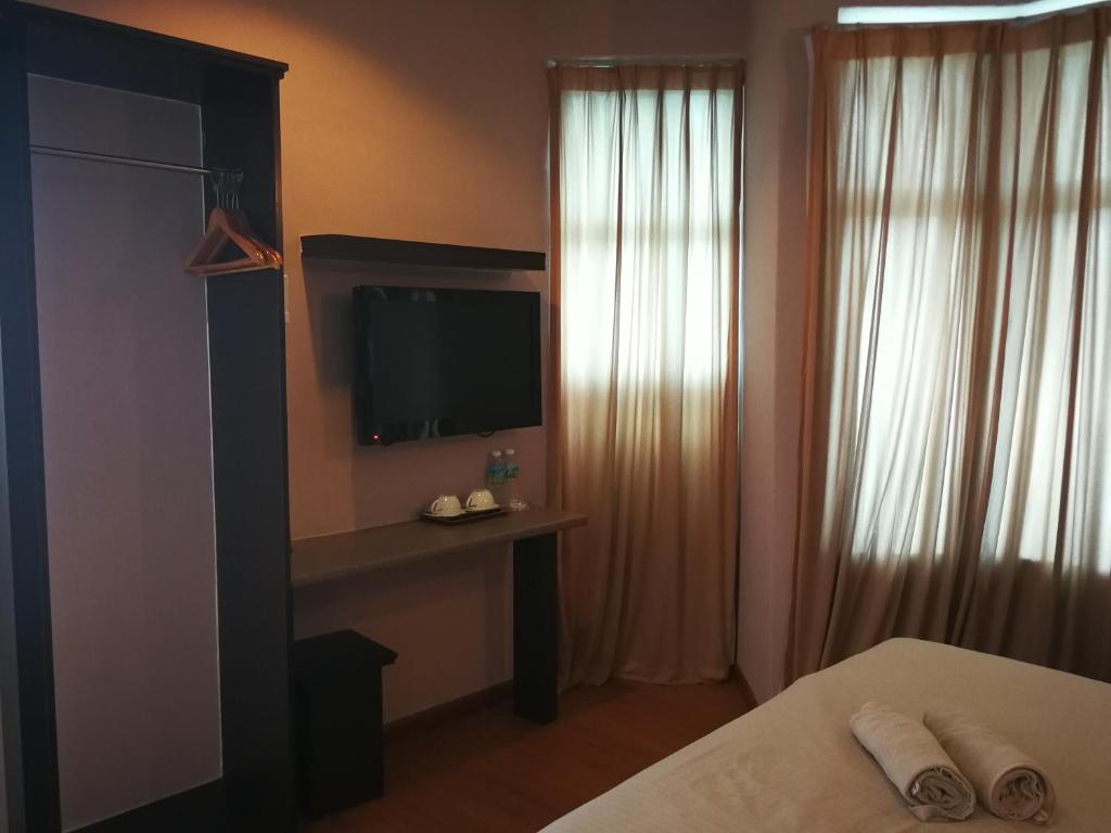 Łóżko lub łóżka w pokoju w obiekcie Hotel Economy Kapar