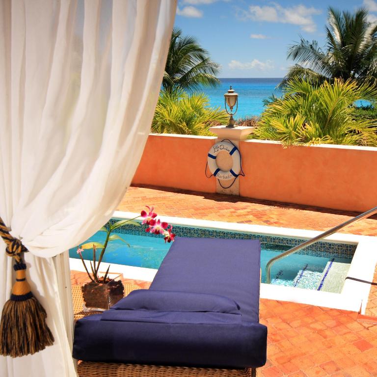 a view of the ocean from the balcony of a resort at Little Arches Boutique Hotel - Adults Only in Christ Church