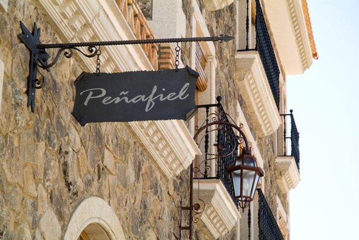 a sign hanging on the side of a building at Complejo Peñafiel in Zarza la Mayor