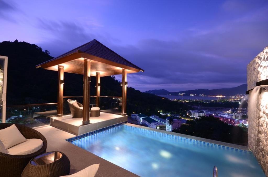 a pool with a gazebo on top of a building at AW ONE Patong Villa in Patong Beach