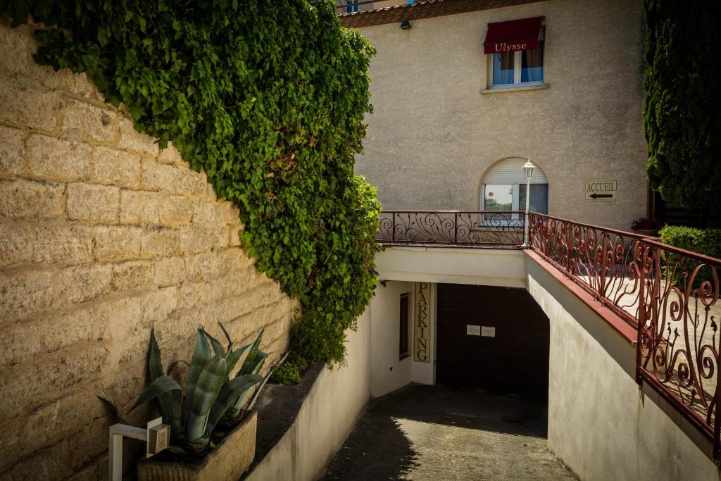 a stairway leading to a building with a plant at Hôtel Ulysse Montpellier Centre in Montpellier