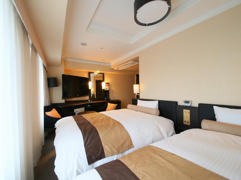 Postel nebo postele na pokoji v ubytování APA Hotel Nihonbashi Hamacho Ekiminami