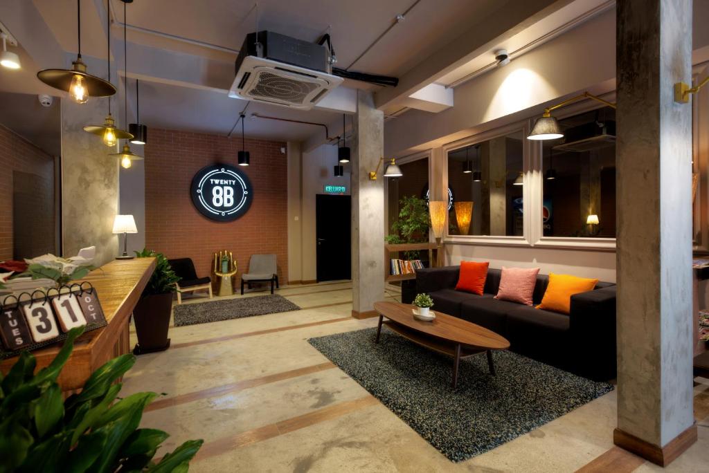 a living room with a couch and a table at Hotel Twenty 8B in Kuala Lumpur