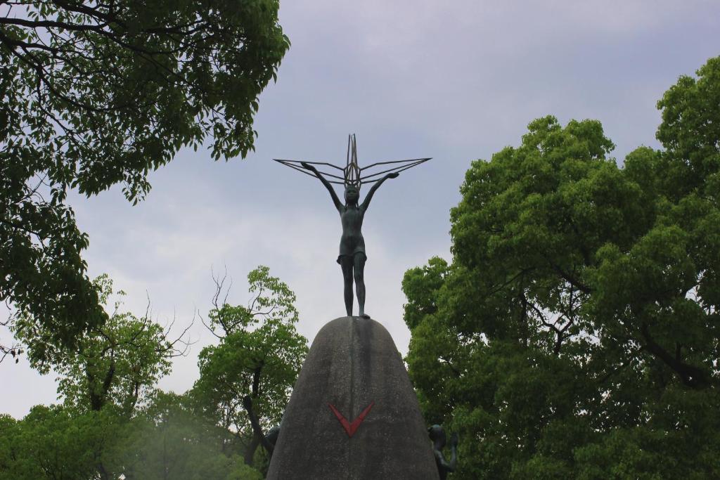 a statue of a woman on top of a rock at Guesthouse COCO Hiroshima (Female Only) in Hiroshima