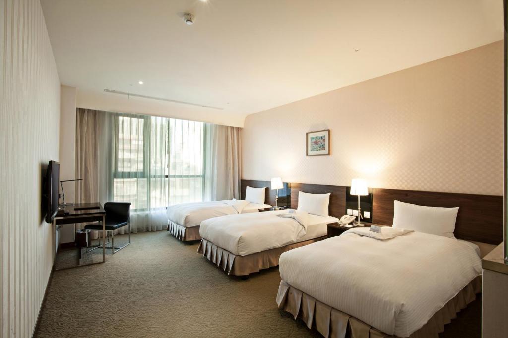 Postel nebo postele na pokoji v ubytování Taisugar Hotel Taipei