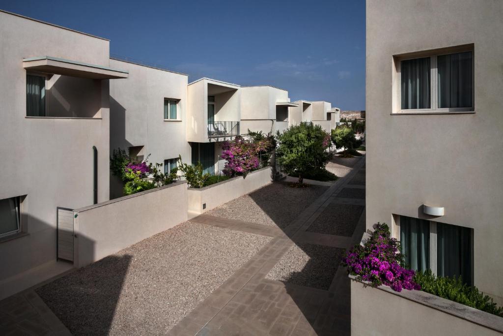 an apartment building with flowers on the balconies at Cala Palme Lampedusa in Lampedusa