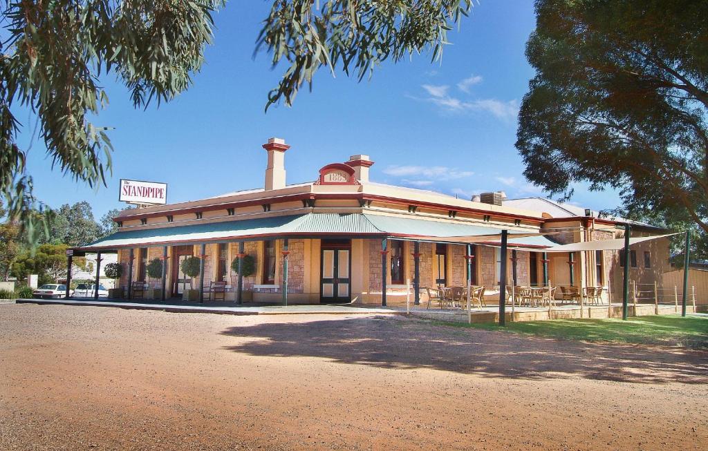 an old building with a sign on top of it at Standpipe Golf Motor Inn in Port Augusta