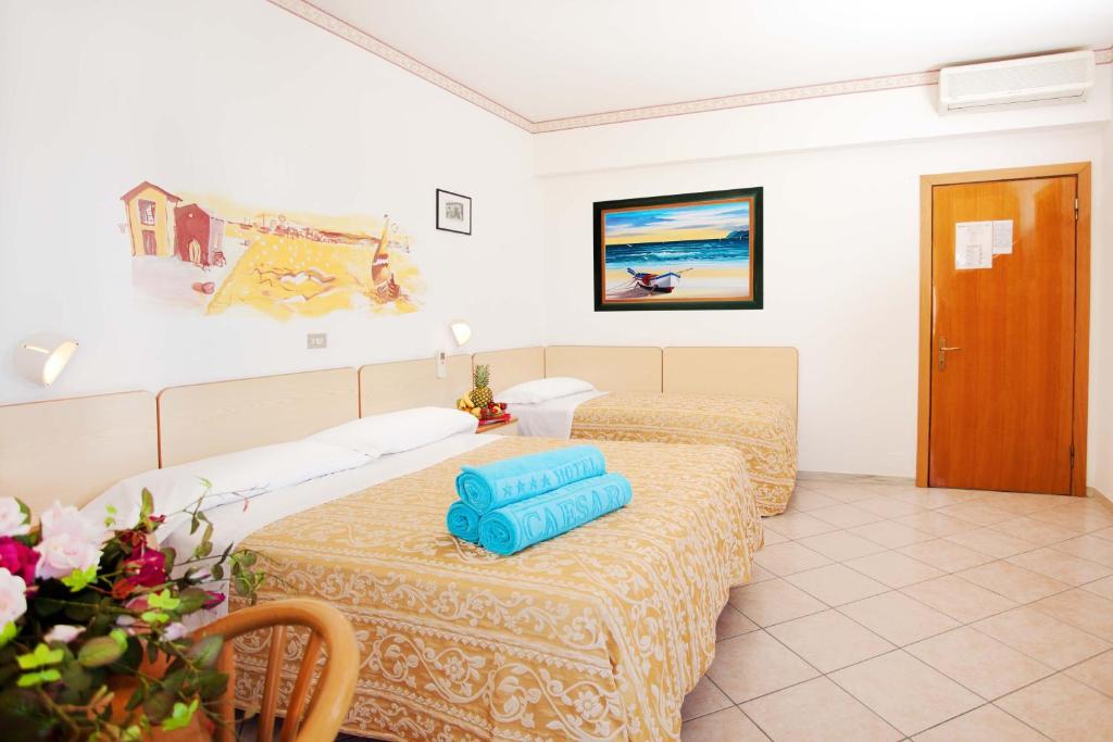Postel nebo postele na pokoji v ubytování Hotel Caesar
