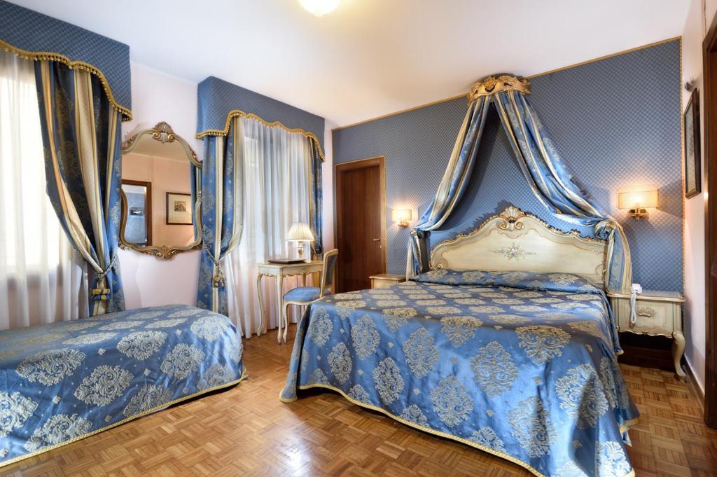 Postel nebo postele na pokoji v ubytování Royal San Marco Hotel