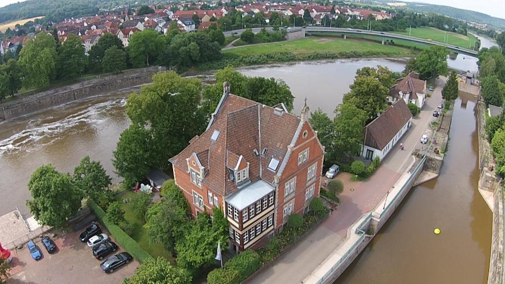 an aerial view of a large house in the middle of a river at Ferienwohnung INSELVILLA in Hameln