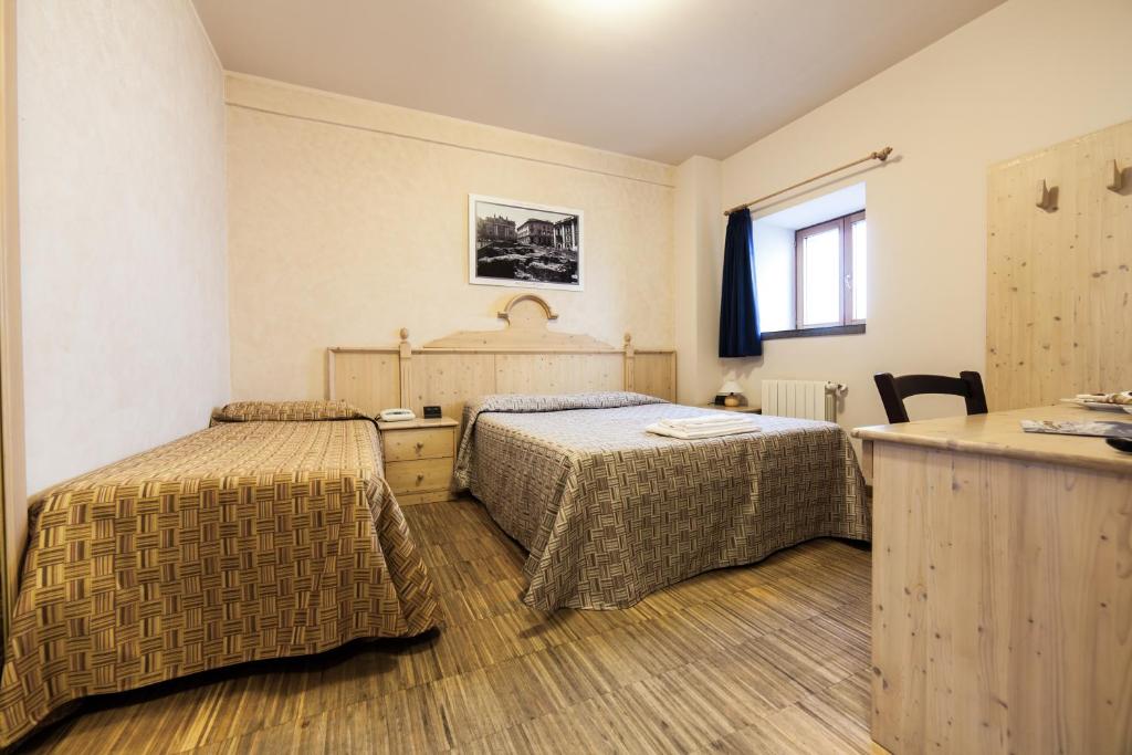 Letto o letti in una camera di Rifugio Sapienza