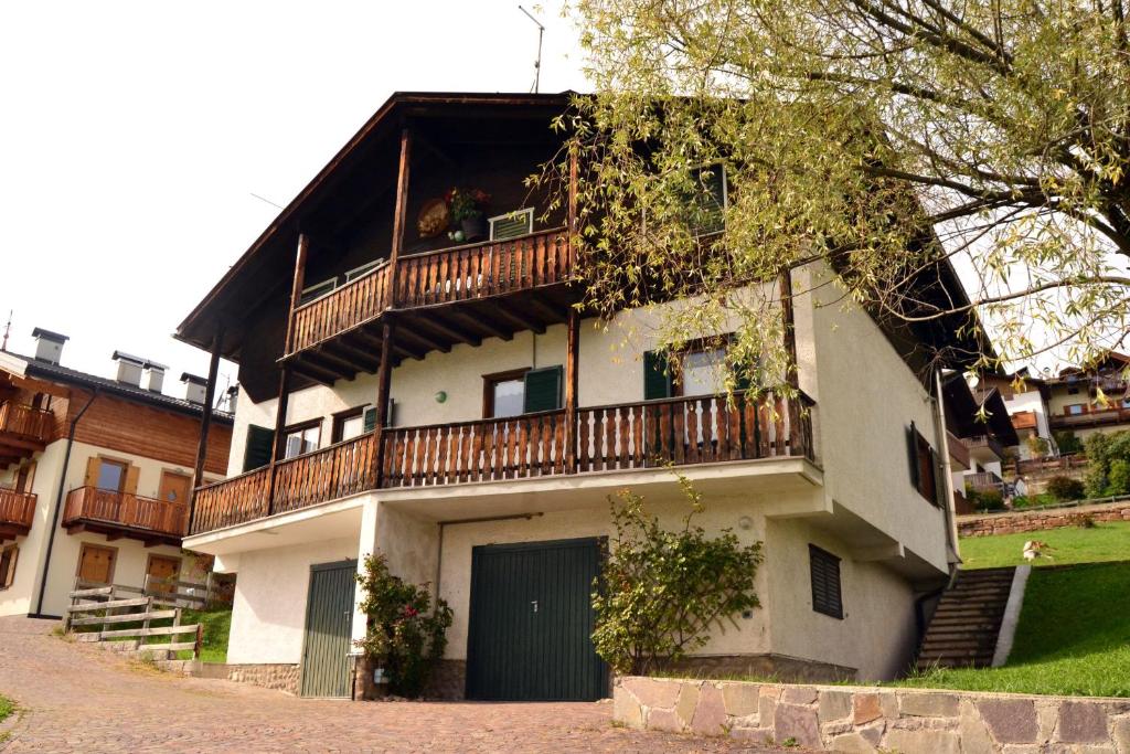 a house with a balcony on top of it at Casa del Salice in Carano