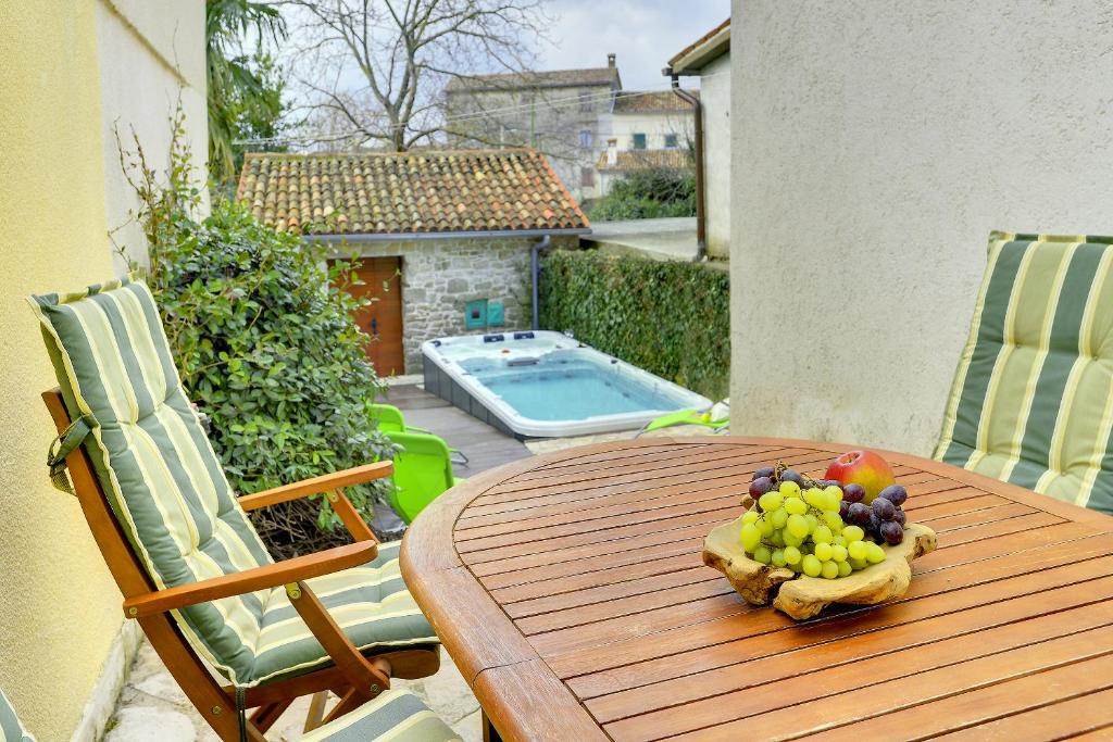 a wooden table with a bowl of fruit on it at Holiday Home Ruža in Gračišće