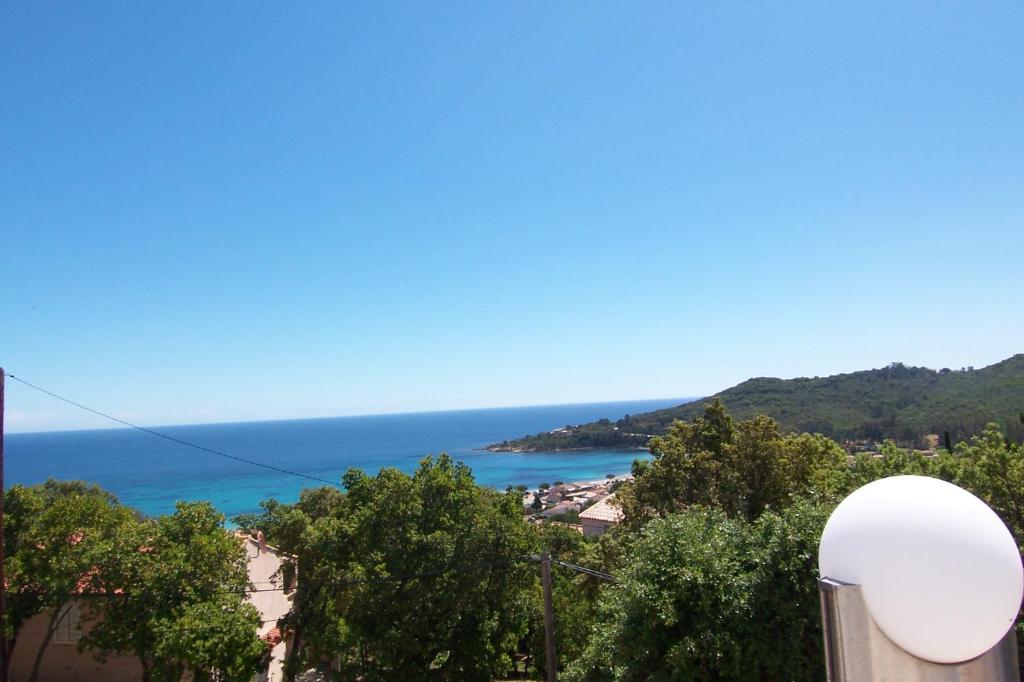 a view of the ocean from a building at Maja in Favone