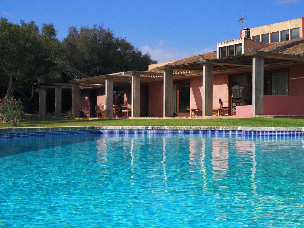 a large swimming pool in front of a house at Cucurutxa in Mahón