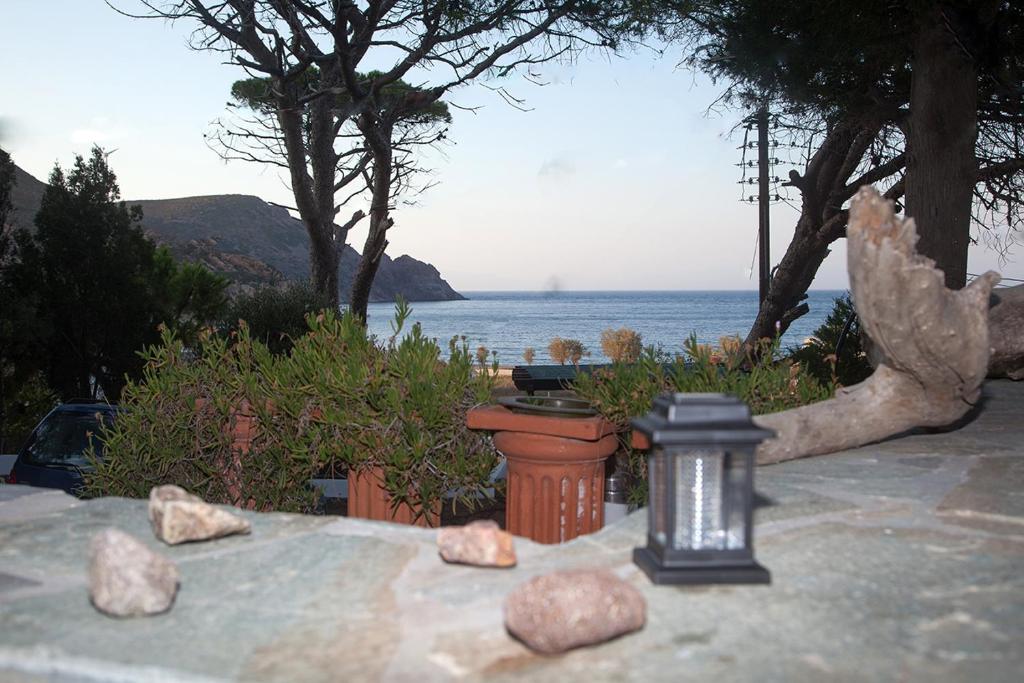 a view of the ocean from a patio with rocks at Lampi's House in Patmos