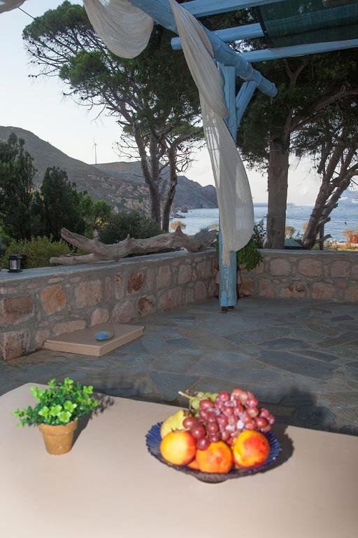 a plate of fruit sitting on a table at Lampi's House in Patmos