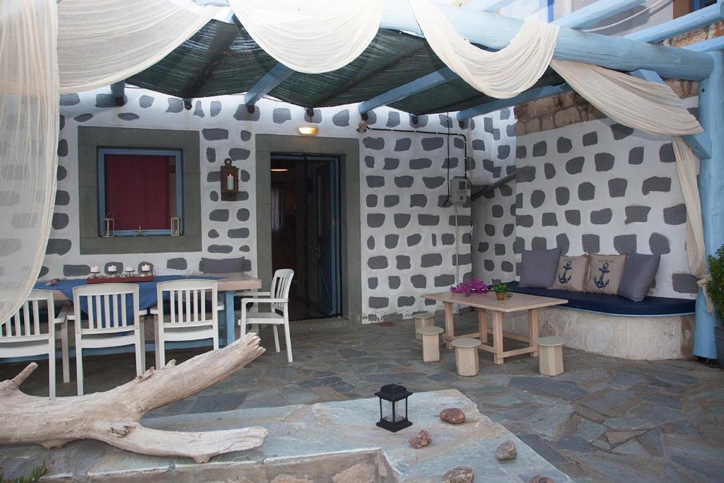 a patio of a house with a table and chairs at Lampi's House in Patmos