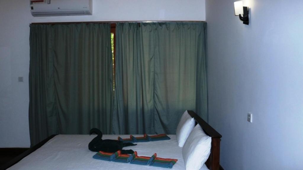Postel nebo postele na pokoji v ubytování Birds Paradise Hotel