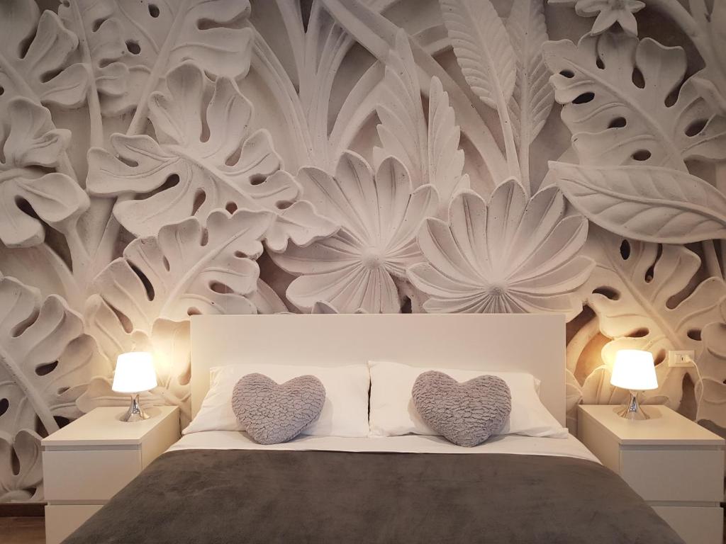 a bedroom with a bed with two hearts on it at Bsuites Scrovegni in Padova