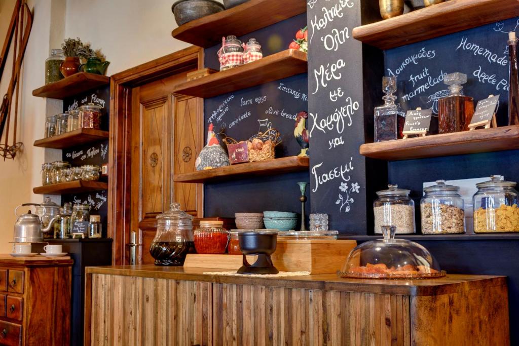 a kitchen with a counter with a chalkboard on the wall at Gastronomy Hotel Kritsa in Portaria