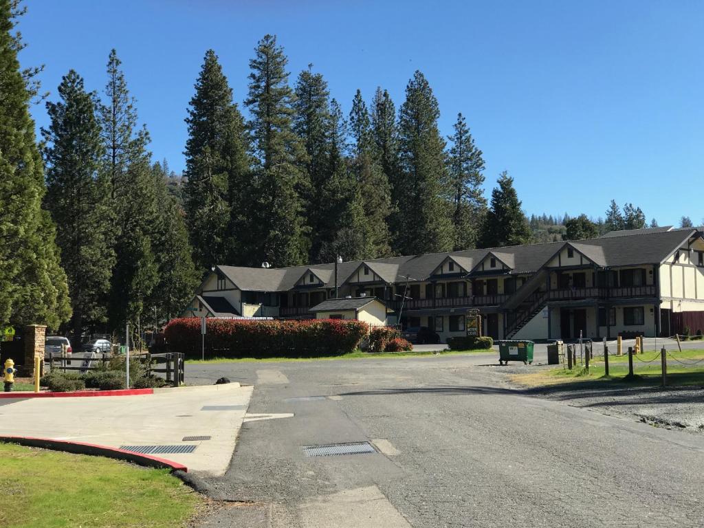 a large house with a road in front of it at Wildwood Inn in Twain Harte