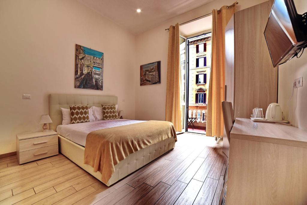a bedroom with a bed and a large window at Coladir Guest House in Rome