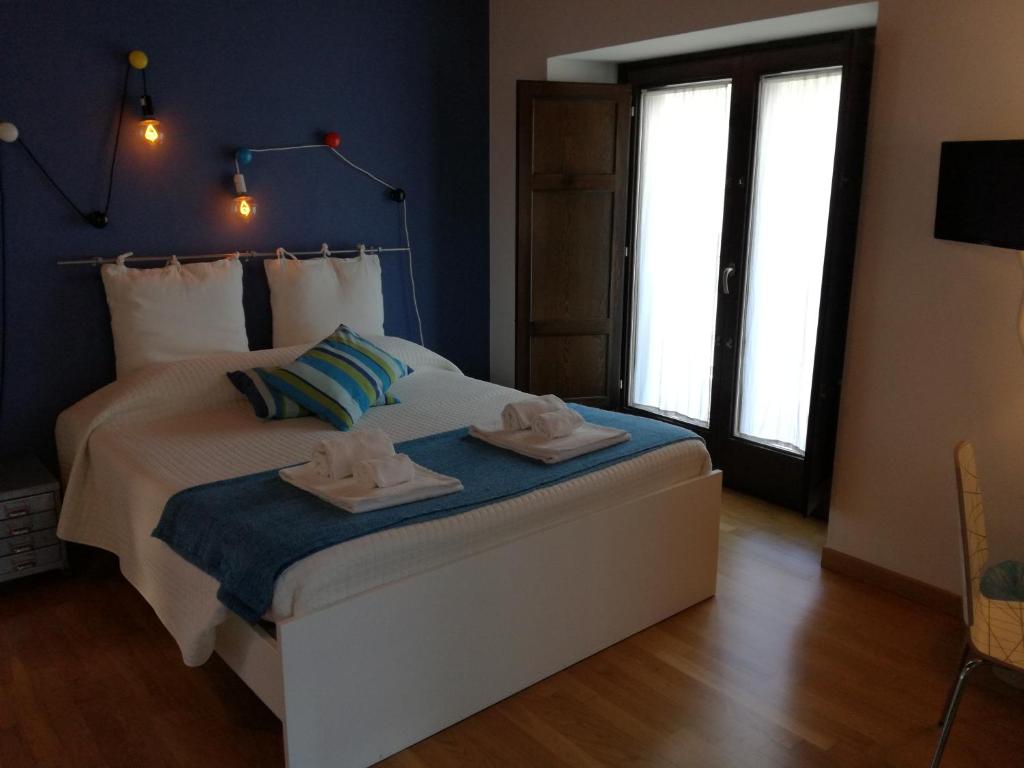 a bedroom with a bed with two towels on it at Altevolte Rooms in Catania