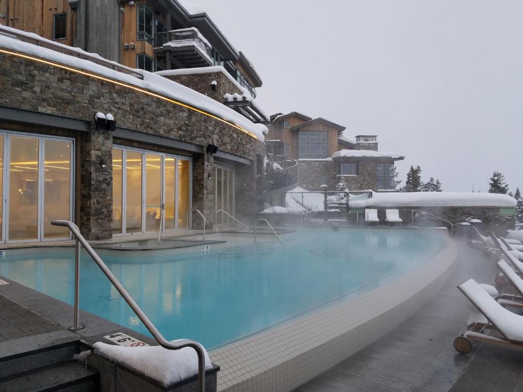 a large swimming pool with snow on it at Stein Eriksen Residences in Park City