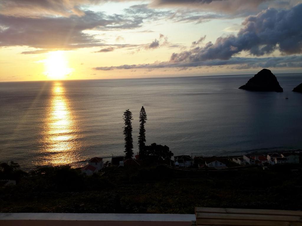 a sunset over the ocean with at Casa da Fajãzinha in Vila do Porto